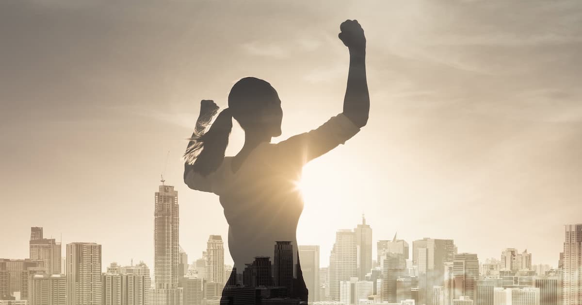 Strong confident young female in the city flexing her arms. People victory, confidence and achieving goals concept.