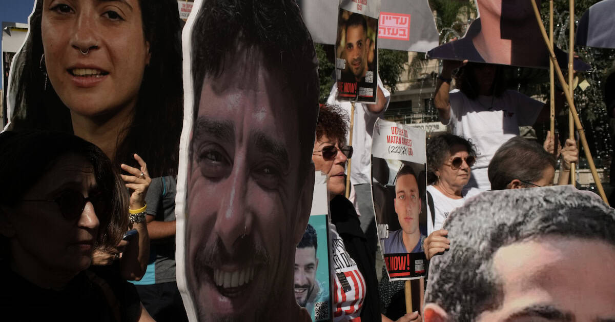 Relatives and supporters of Israeli hostages held by Hamas in the Gaza Strip carry posters with portraits of their loved ones