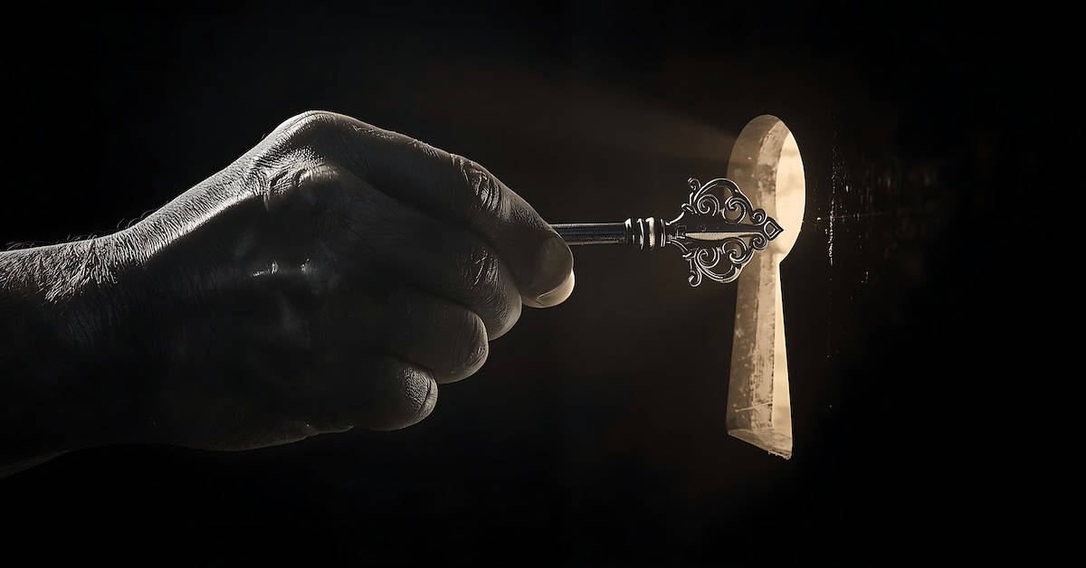 The black and white image shows a hand holding a key and pointing at a door through the keyhole, representing curiosity and the desire to know.