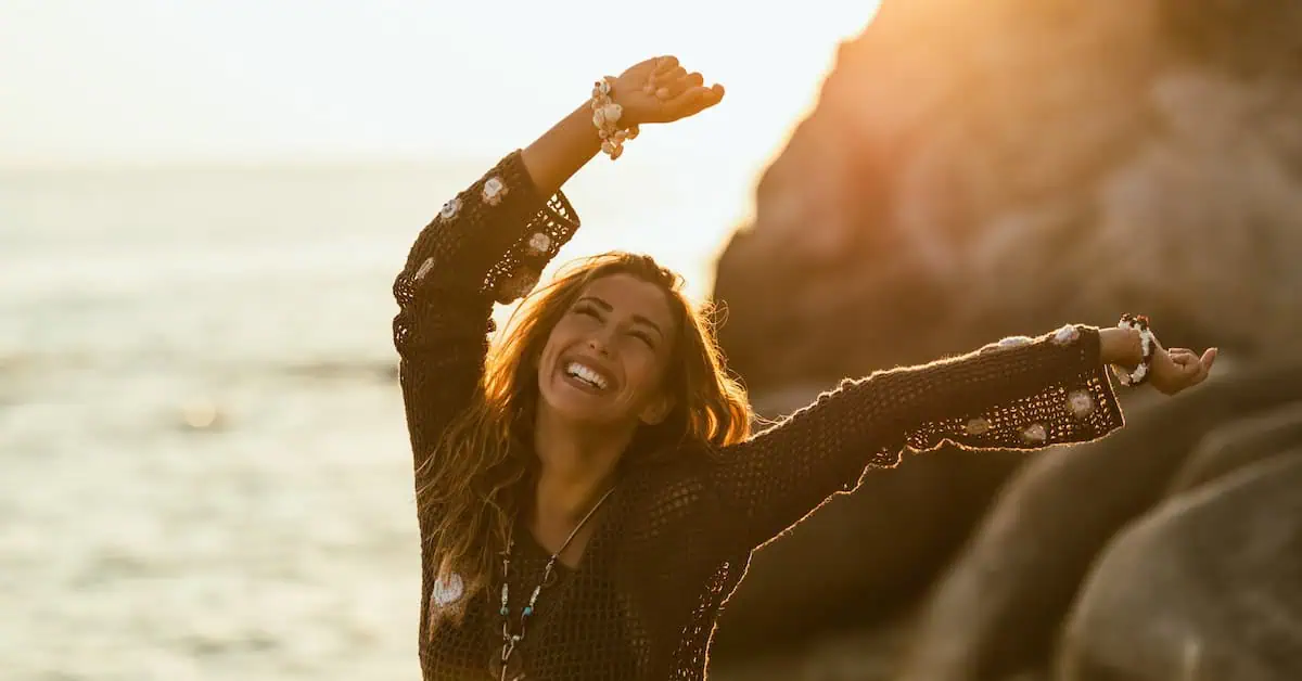 Woman Dancing on a Beach at Sunset