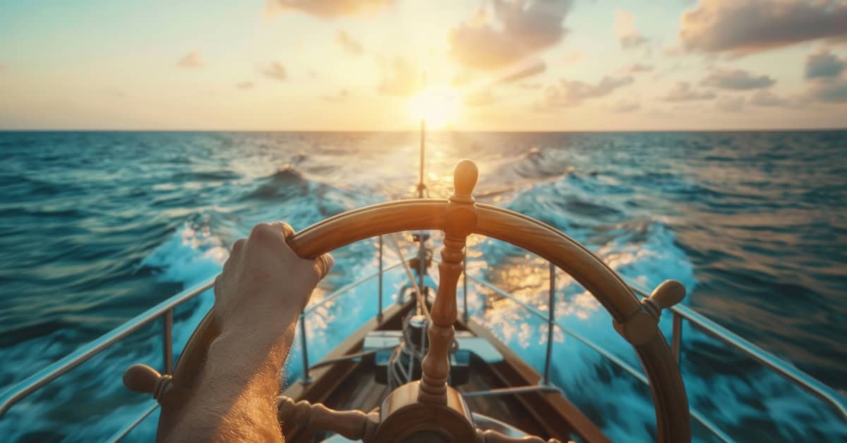 A ship captain is navigating a ship in sea.
