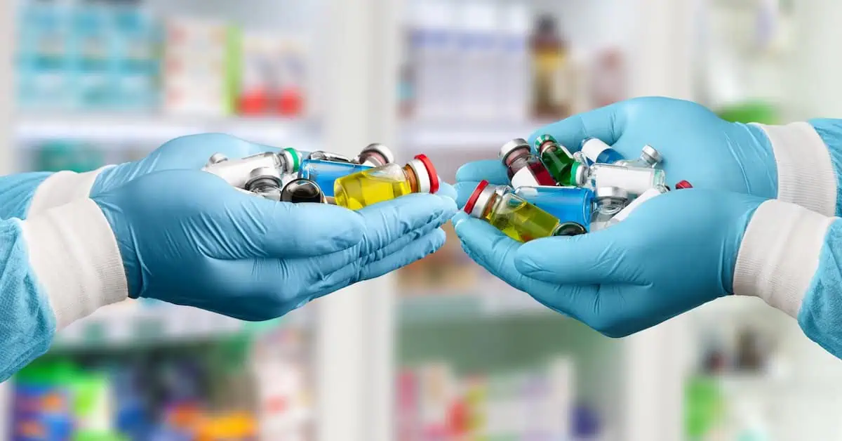 Hand of a medical Researcher holding COVID-19 Vaccines.